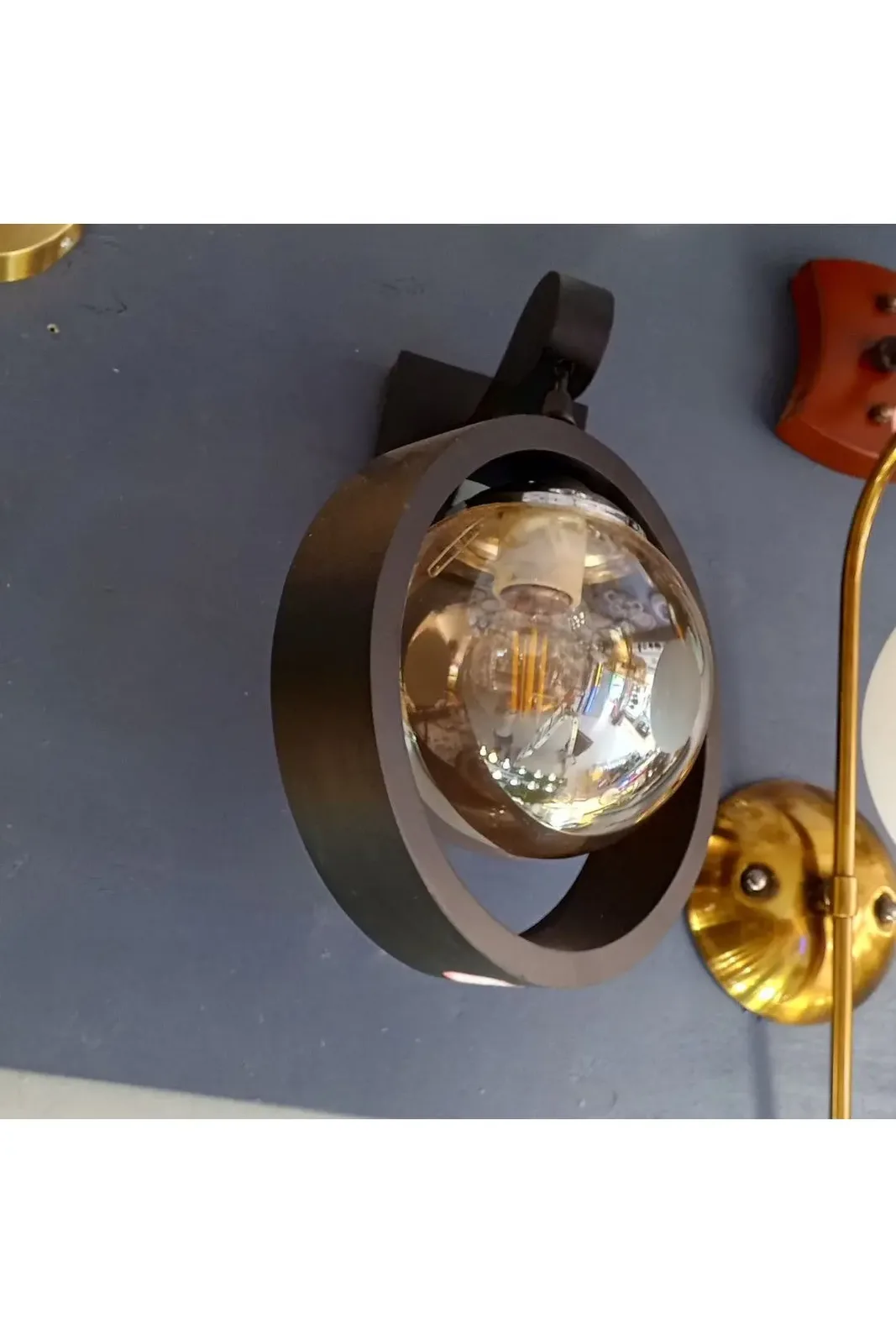 Modern, circular wall-mounted lamp