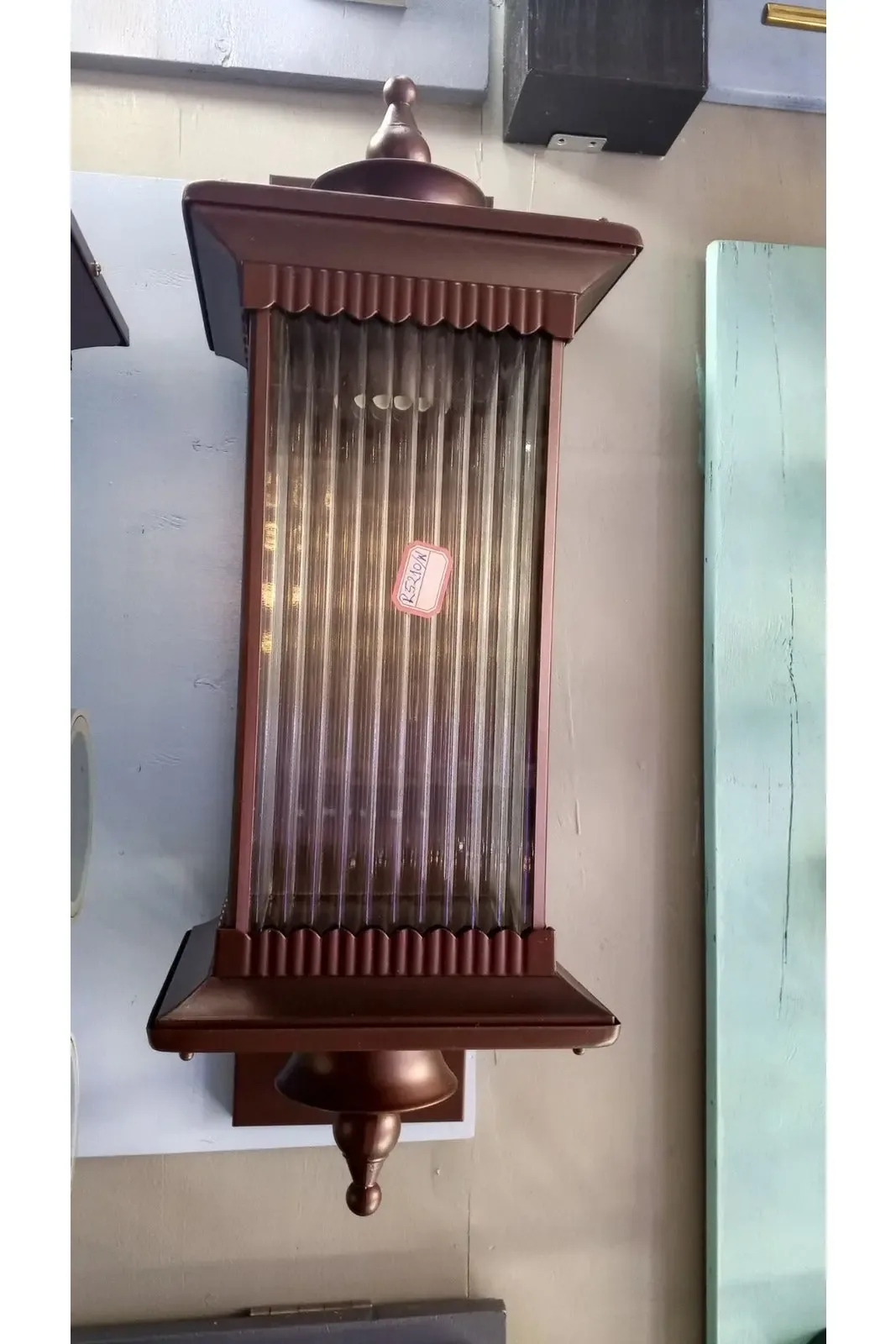 Bronze-colored, rectangular wall sconce.